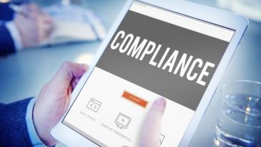 Compliance: a man starts to fill in a compliance questionnaire on a tablet